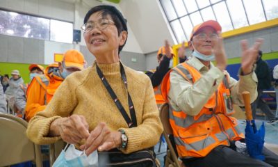 Josephine Josephine Hui, 75, at a local security event in Oakland sitting in a gymnasium as an audience member at a community meeting