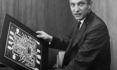 Robert Noyce in his office at Fairchild Semiconductor holding diagrams of semiconductors.