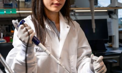 Julia Juong working with a stripette seen at a lab bench
