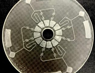 a transparent circle with a symmetrical white pattern of channels